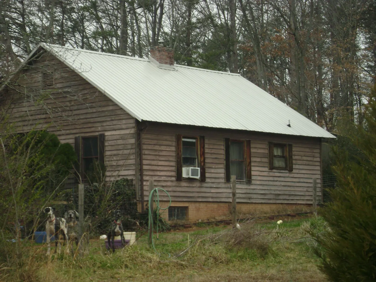 White metal roof on an old wood sided farmhouse, from a Metal Roof Installation job in Kitzmiller